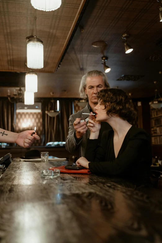 a group of people sitting at a bar, a portrait, by Dan Frazier, unsplash, purism, jim jarmusch, apothecary, smoking, 3 / 4 wide shot