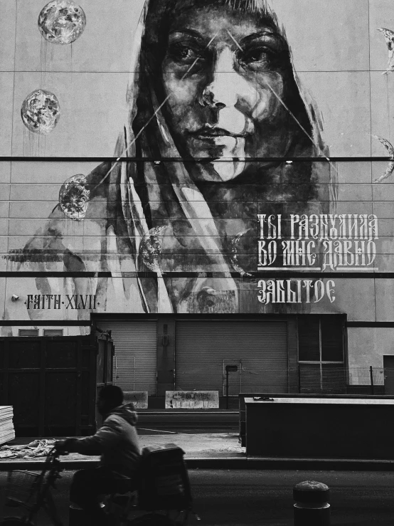 a man sitting on a bench in front of a building, a poster, by andrei riabovitchev, bob marley, the photography artwork, leonardo da vinci), stencil