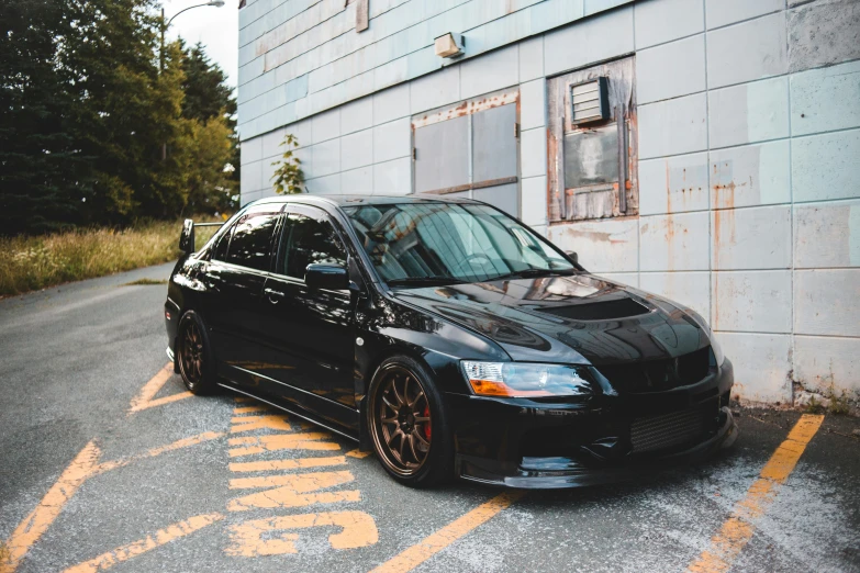 a black car parked in front of a building, pexels contest winner, samurai vinyl wrap, late 2000’s, full pose, 2263539546]