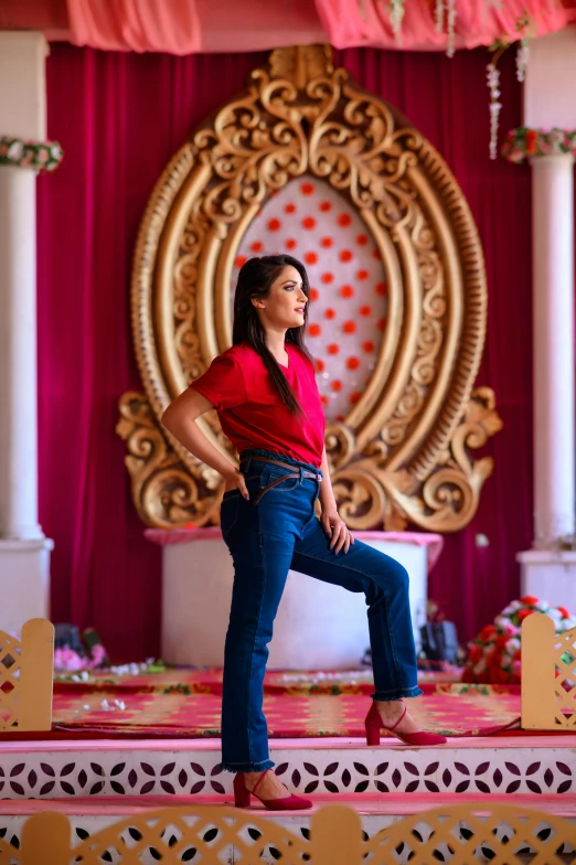 a woman in a red shirt and blue jeans