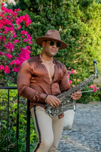a man in a hat is holding a saxophone