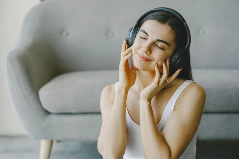 a woman sitting on the floor listening to headphones, trending on pexels, making the best smug smile, sitting in a lounge, wearing a headband, hypnosis