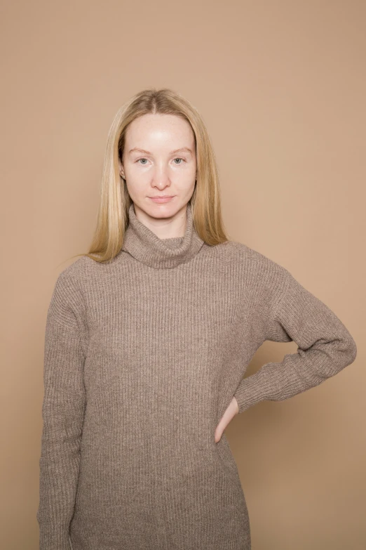 a girl posing for the camera with her hands on her hips