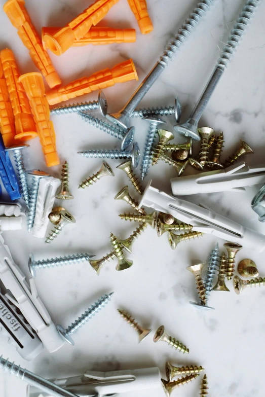 a bunch of screws sitting on top of a table, art materials, thumbnail, wide overhead shot, bright construction materials