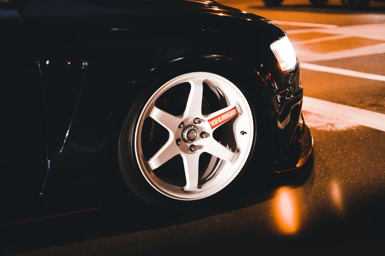 a wheel on a black sports car is seen