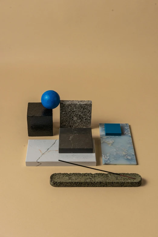 a group of objects sitting on top of a table, suprematism, blue sand, product image, slate, smoke