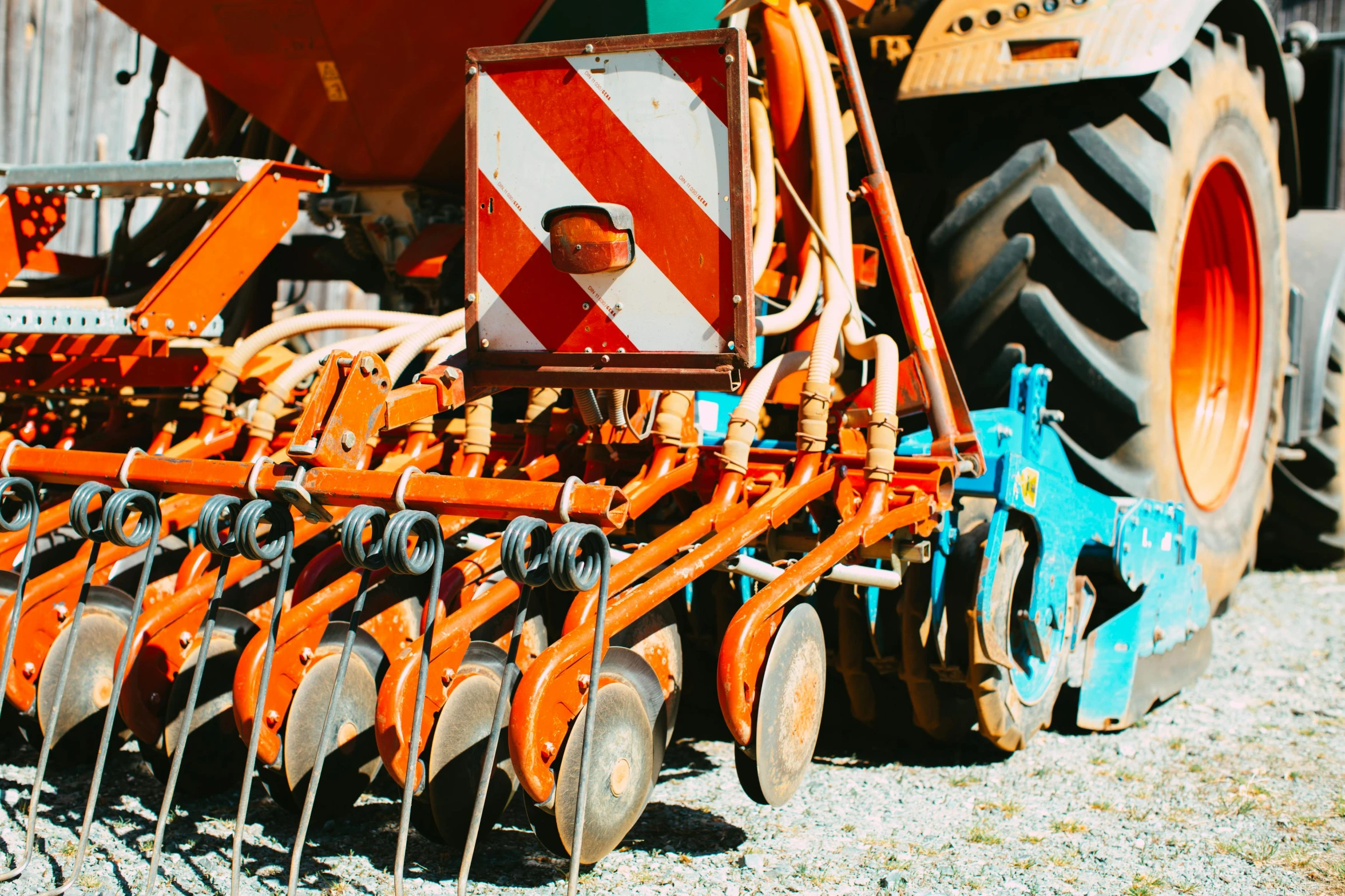 a tractor that is sitting in the dirt, unsplash, figuration libre, orange and cyan paint decals, industrial machinery, worksafe. instagram photo, hoses