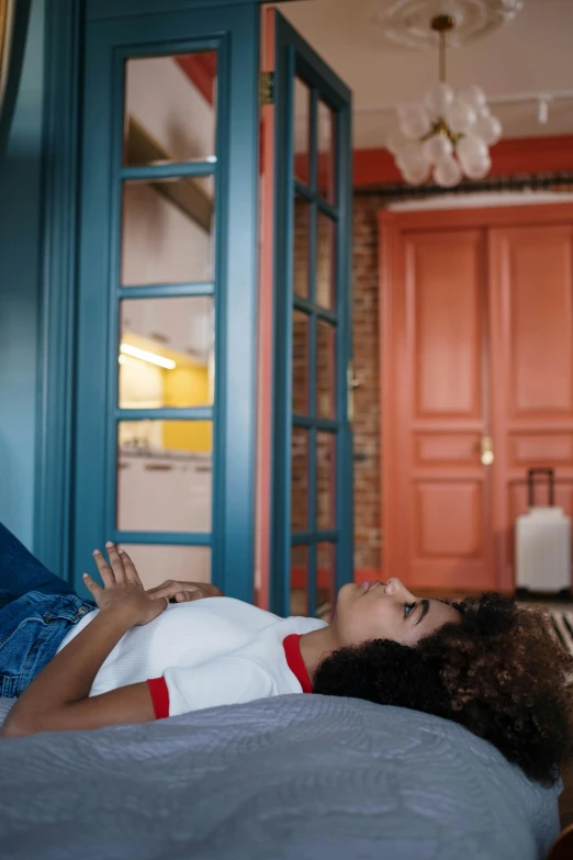 a girl laying on top of a bed with a pillow