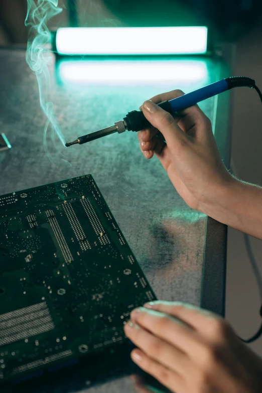 a person is working on a circuit board, an engraving, pexels contest winner, holding a torch, promo image, panel, sci-fi computer