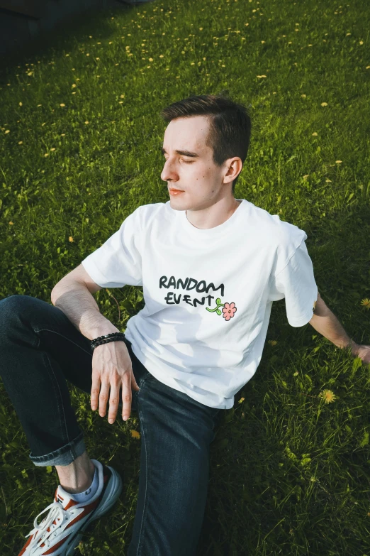 a man sitting on top of a lush green field, an album cover, featured on reddit, graffiti, wearing a marijuana t - shirt, official product image, large friendly eyes, /r/razer