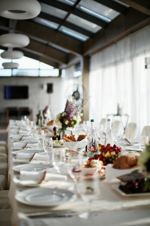 a long table is set with plates and glasses, a picture, soft natural lighting, white backdrop, indoor, heaven