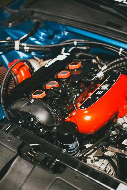 a close up of the engine of a car, by Dan Christensen, reddit, renaissance, orange and blue tones, red mini cooper s, 15081959 21121991 01012000 4k, aftermarket parts