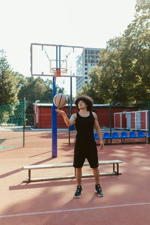 a woman standing on a basketball court holding a basketball, by Attila Meszlenyi, trending on dribble, black teenage boy, square, bench, shot with sony alpha