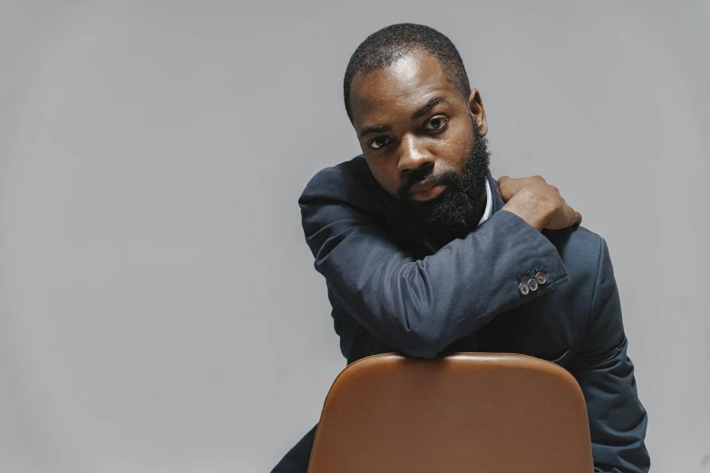 an african american man with a goatee wearing a jacket and shirt