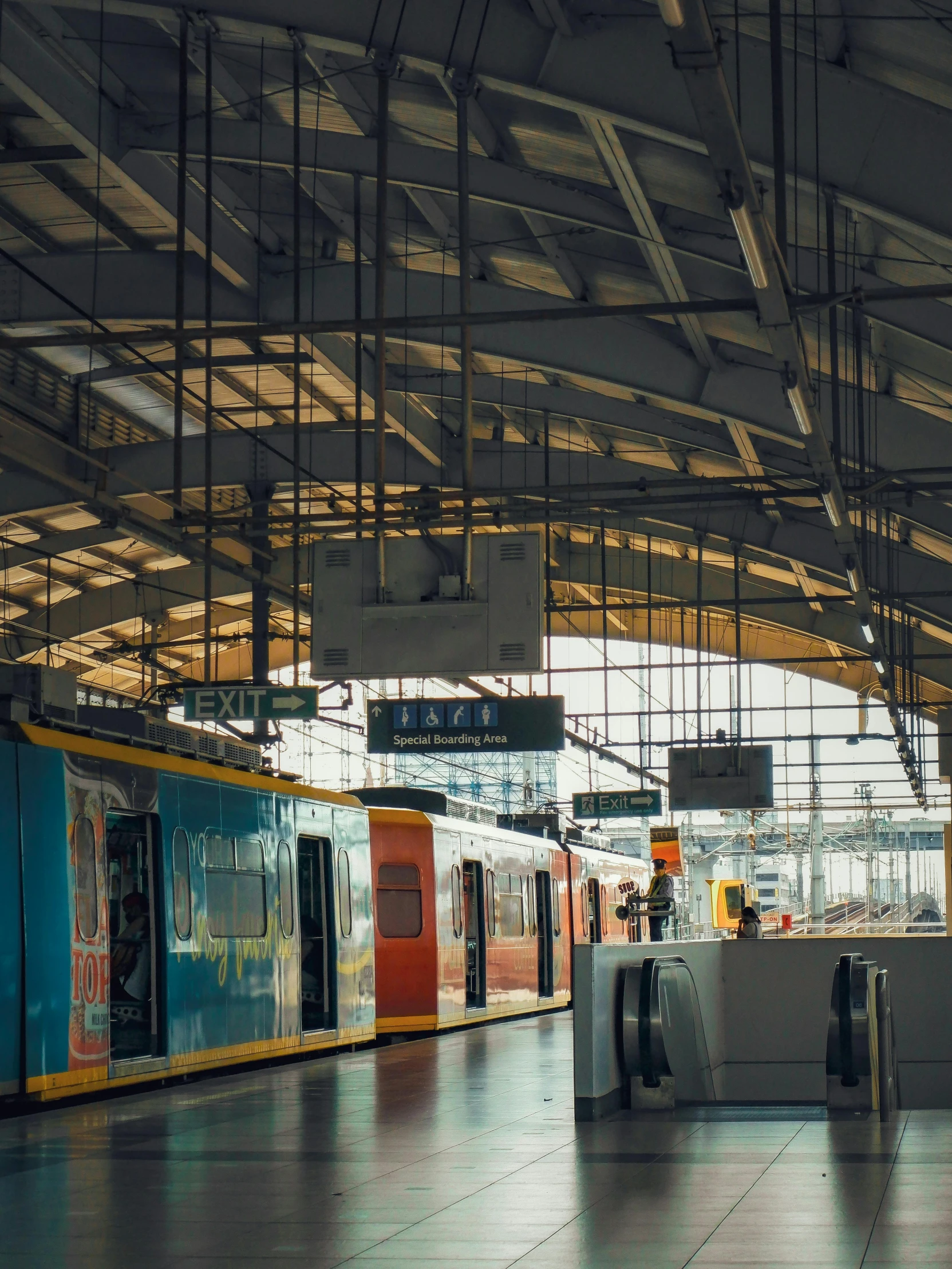 a train station with some trains stopped at the station