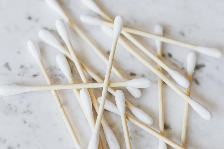 a pile of toothpicks sitting on top of a table, white marble and gold, lots of white cotton, thumbnail, product shot