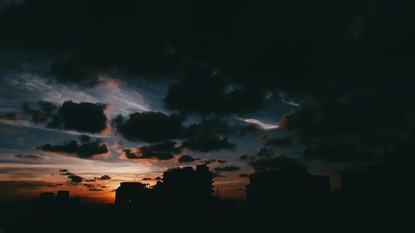 the sun is setting behind the clouds in the sky, inspired by Elsa Bleda, unsplash contest winner, dark cityscape, ☁🌪🌙👩🏾, late night melancholic photo, colorful and dark