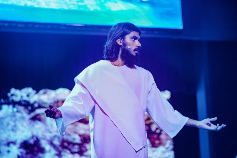 a man that is standing on a stage, an album cover, unsplash, antipodeans, dressed like jesus christ, ( ( theatrical ) ), ariel perez, h3h3