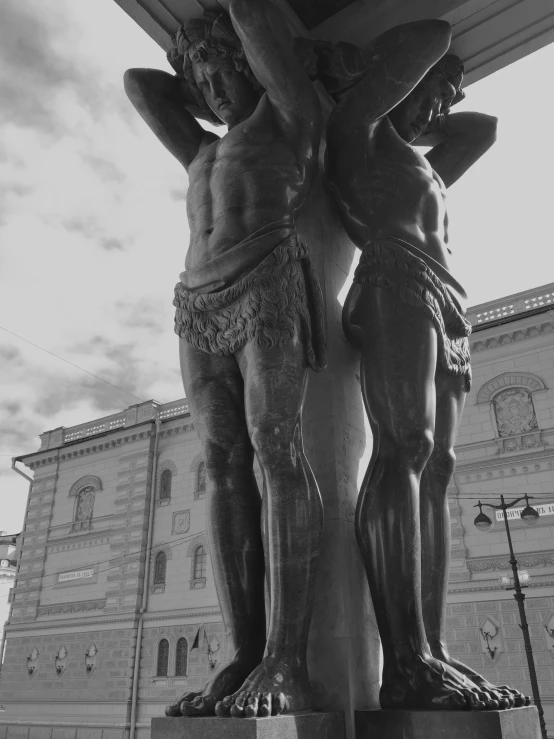 a black and white photo of two statues in front of a building, a statue, inspired by Sir Jacob Epstein, pexels contest winner, mannerism, crucifixion, stockholm city portrait, beautiful!!!! museum photo, ayanamikodon and irakli nadar