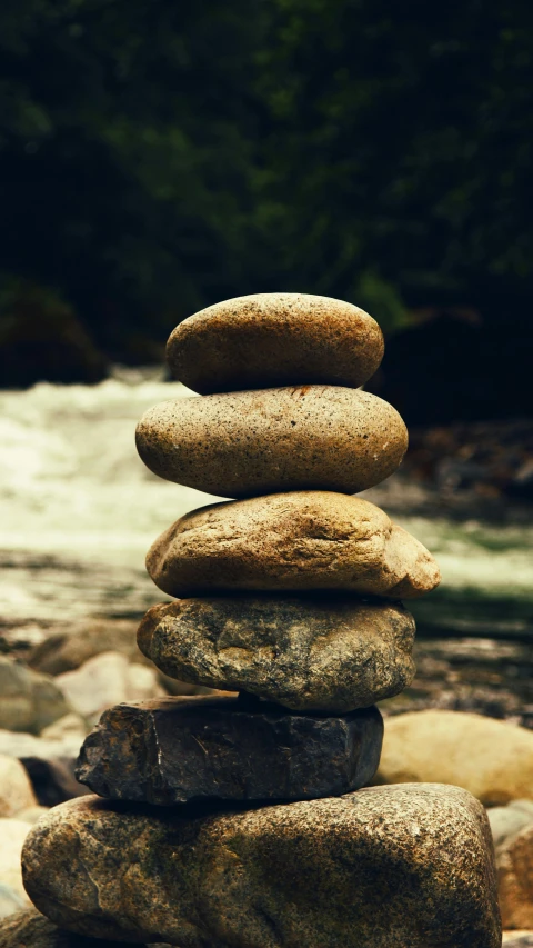 a pile of rocks sitting on top of a river bank, inspired by Saitō Kiyoshi, unsplash, las pozas, totem, islamic, 15081959 21121991 01012000 4k