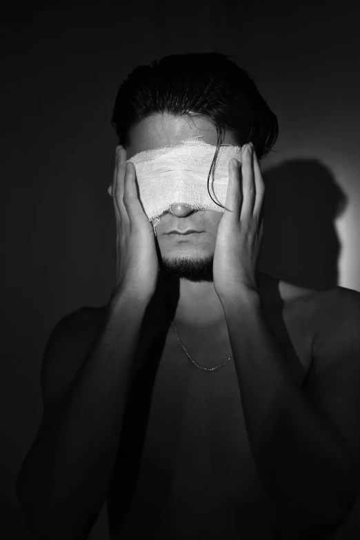 a man with a blindfold covering his eyes, a black and white photo, by Alexis Grimou, black eye patch over left eye, ayamin kojima, ignant, covered in bandages