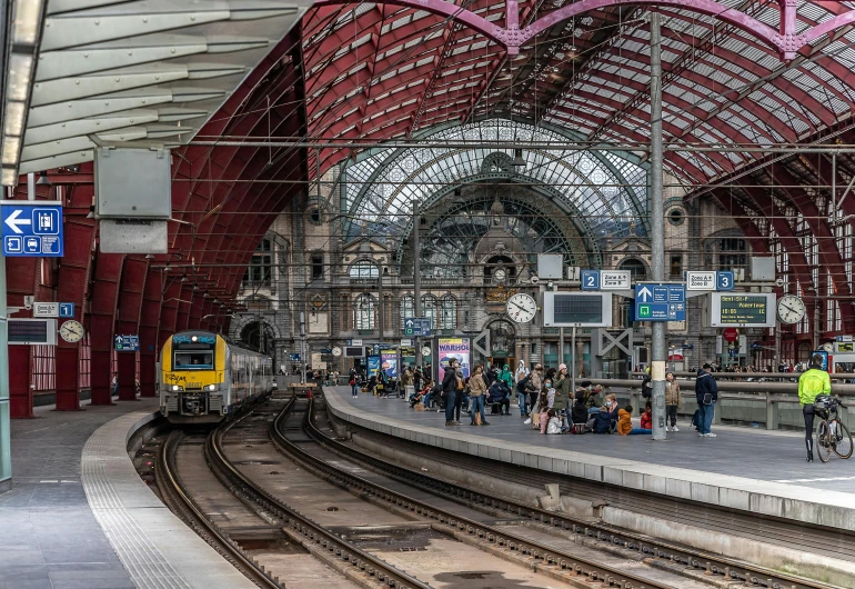 a train pulling into a train station next to a platform, by Daniel Seghers, pexels contest winner, art nouveau, square, wim crouwel, built on a small, panoramic