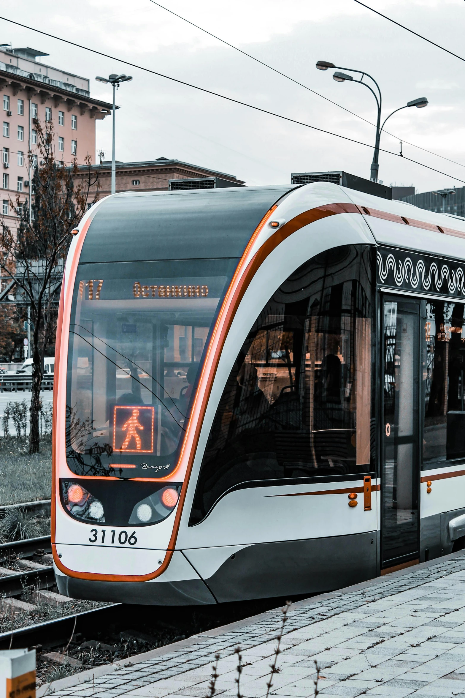 a modern train pulling up to a station