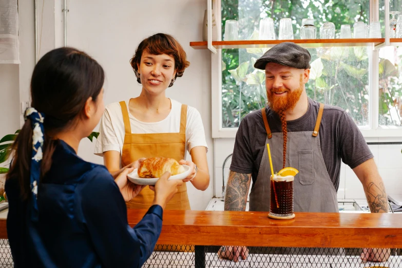 a couple of people that are standing at a table, pexels contest winner, aussie baristas, offering a plate of food, avatar image, small hipster coffee shop