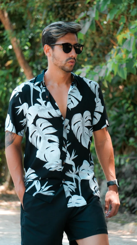 a man riding a skateboard down a street, inspired by Patrick Adam, chest covered with palm leaves, summer shirt, with a black dark background, modelling