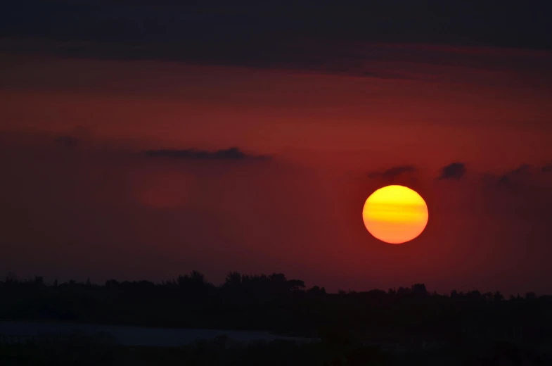 the sun is setting in the dark sky, pexels contest winner, romanticism, digital yellow red sun, hot and humid, landscape photo, 2 0 0 mm wide shot