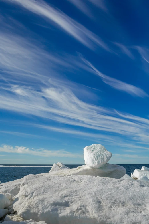 the snow covered rock sits on a sunny day