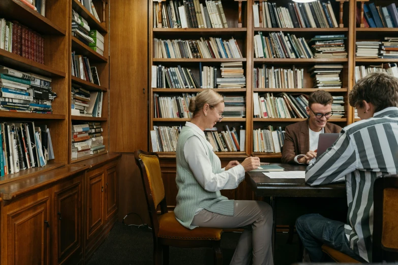 a couple of people sitting at a table in a library, lachlan bailey, scientific study, alessio albi, sydney hanson