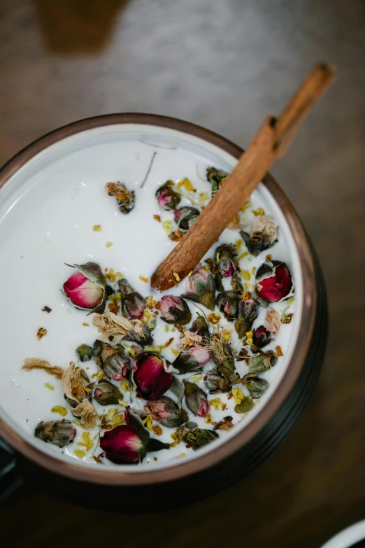 a close up of a bowl of food on a table, renaissance, dried petals, yogurt, thumbnail, apothecary