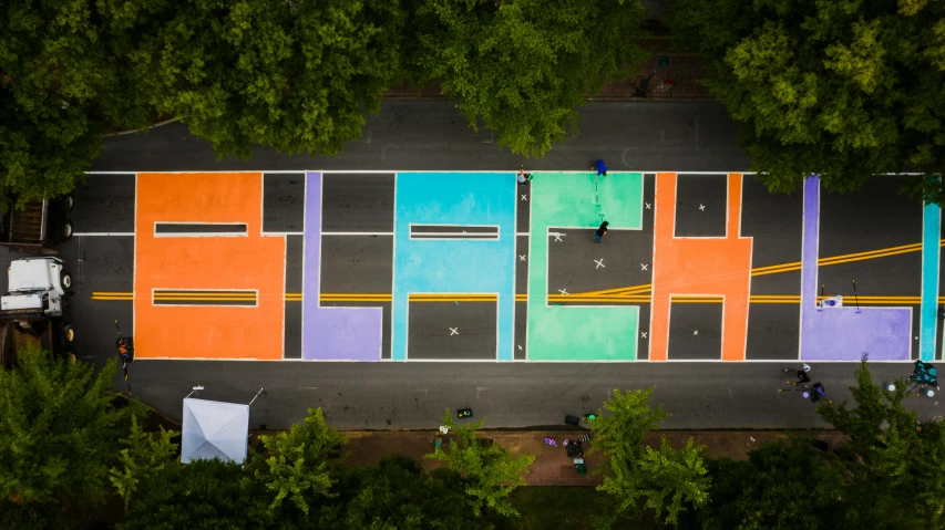 an aerial view of a basketball court surrounded by trees, chalk art, inspired by Washington Allston, flash on, each land is a different color, block party, sc-fi