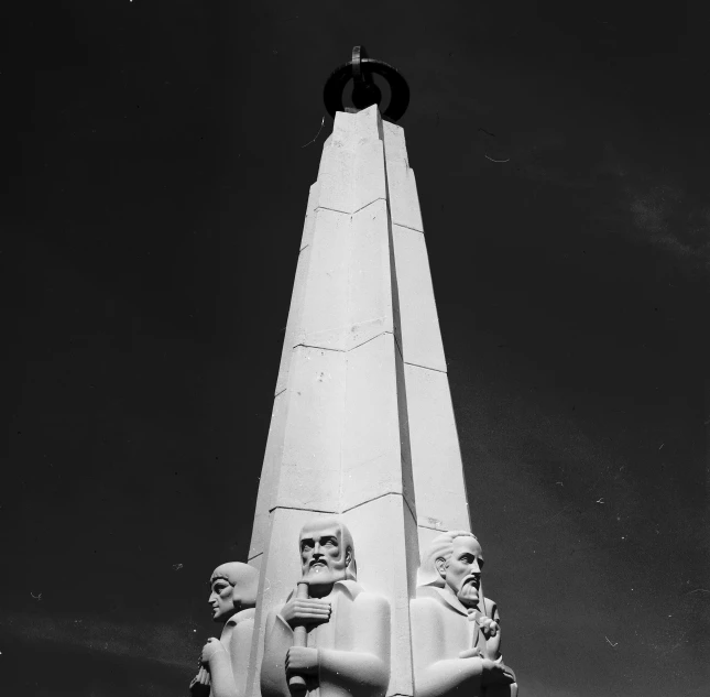 a black and white photo of a monument, by Maurycy Gottlieb, nasa photo, men look up at the sky, lighthouse, detailed faces looking up