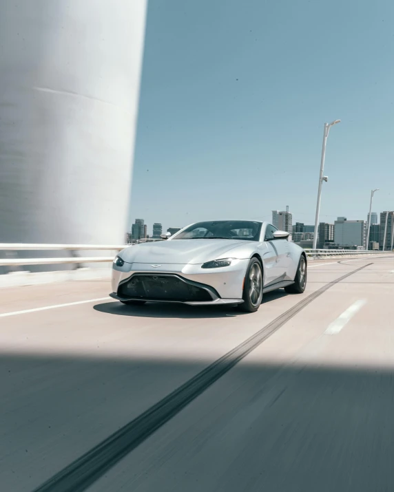 a sleek car driving along a city street