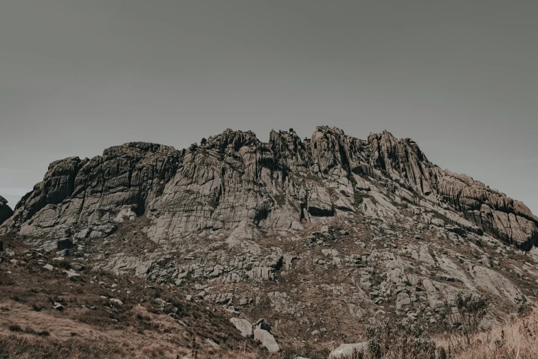 the mountain has very tall, gray mountains in the background