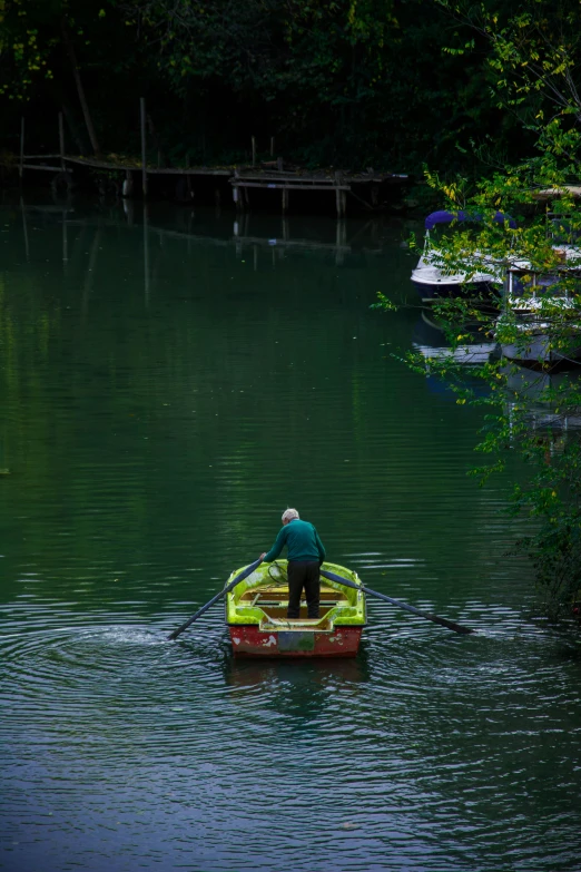 a person in a boat on a body of water, inspired by Frits Thaulow, pexels contest winner, lush green, puerto rico, paul barson, today\'s featured photograph 4k