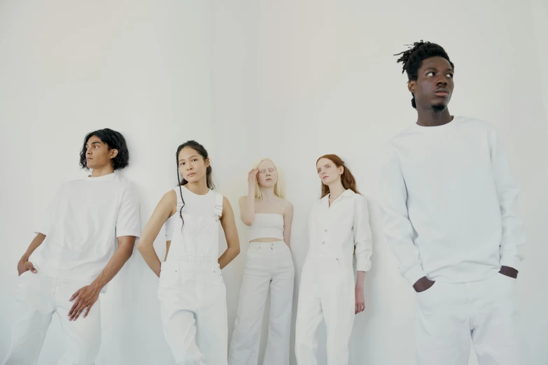 a group of people standing next to each other, by Carey Morris, trending on pexels, renaissance, all white, issey miyake, youth, soft white glow