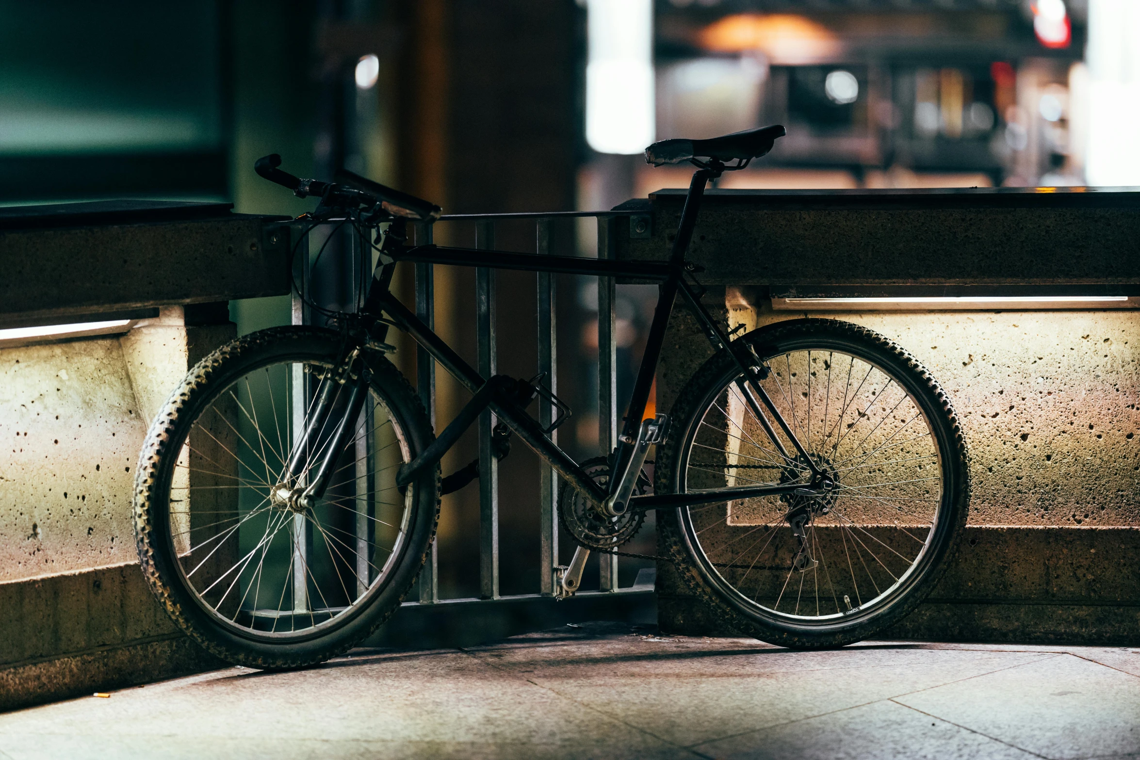 a bicycle leaning against a railing at night, unsplash, realism, bulky build, complex background, stealthy, beaten