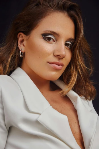 a woman in a white suit posing for a picture, brown hair and large eyes, shiny silver, promo image, tanned beauty portrait
