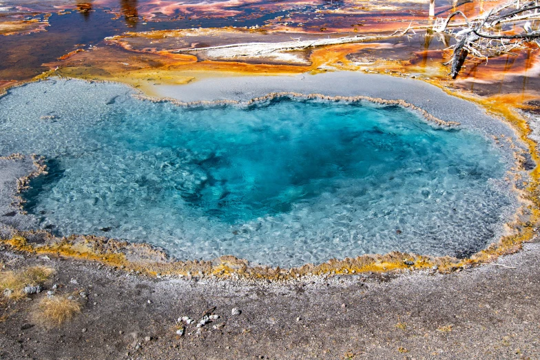 a bright blue hole is seen in this aerial po