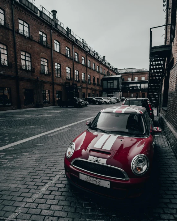 a red car parked on a brick road