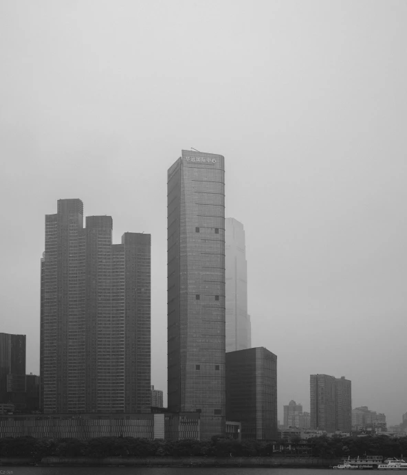 a black and white photo of a city skyline, by David Diao, unsplash contest winner, minimalism, under a gray foggy sky, tall thin build, zezhou chen, three towers