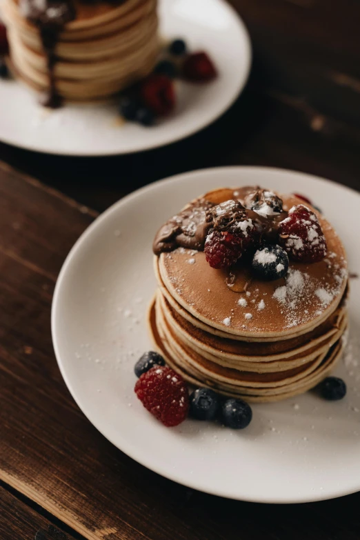 a stack of pancakes sitting on top of a white plate, a still life, trending on pexels, berries, a wooden, gif, cinematic shot