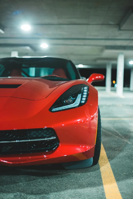 a red sports car parked in a parking garage, pexels contest winner, photorealism, cinematic front lightning, stingray, medium closeup, inspect in inventory image