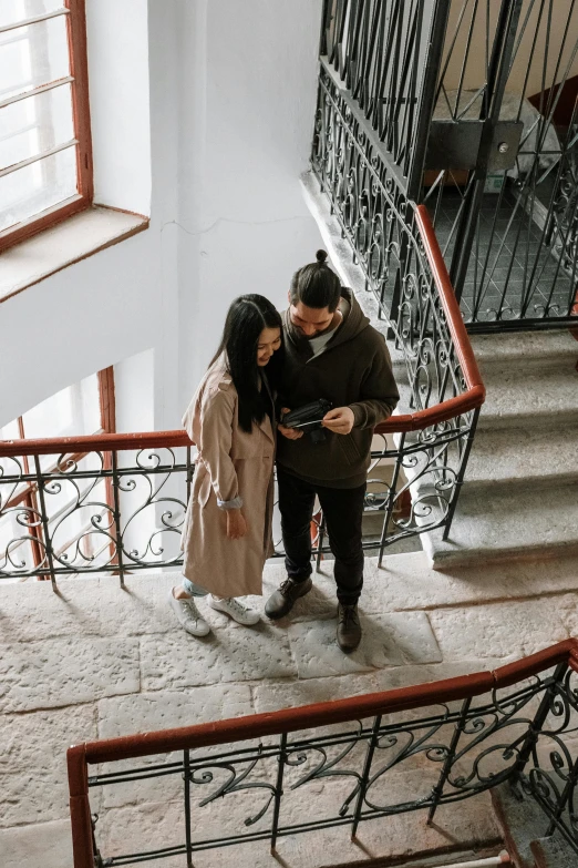 a man and a woman standing on a set of stairs, pexels contest winner, russian girlfriend, programming, high angle, asian man