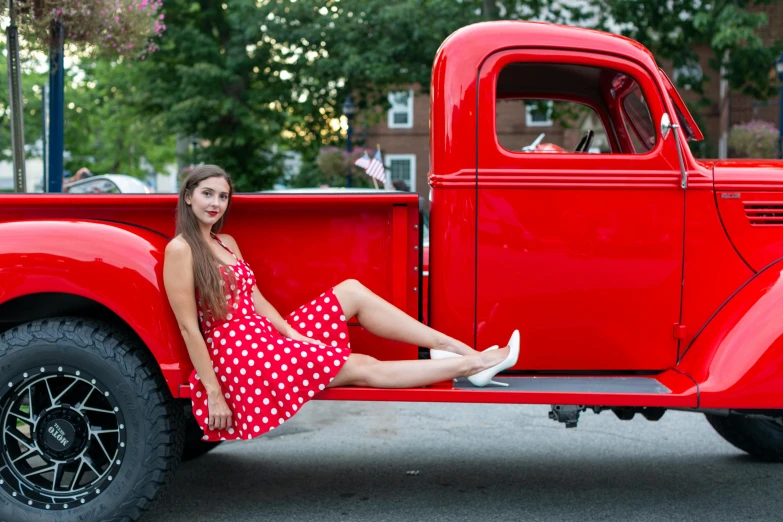 a woman sitting in the bed of a red truck, pexels contest winner, polkadots, square, 15081959 21121991 01012000 4k, full body image