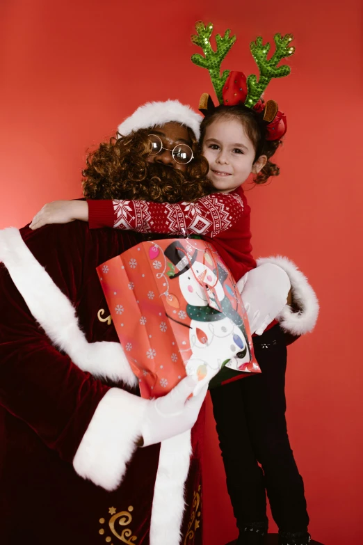 two children who are hugging each other in the christmas po