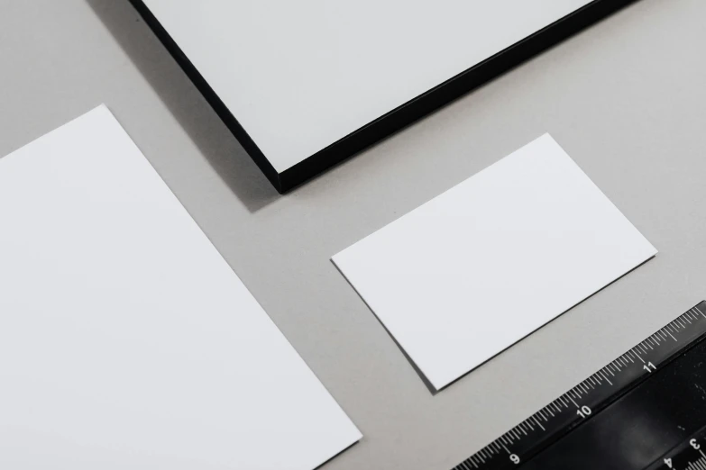 a picture frame sitting on top of a table next to a ruler, a picture, by Harvey Quaytman, cardstock, various sizes, thin porcelain, card template